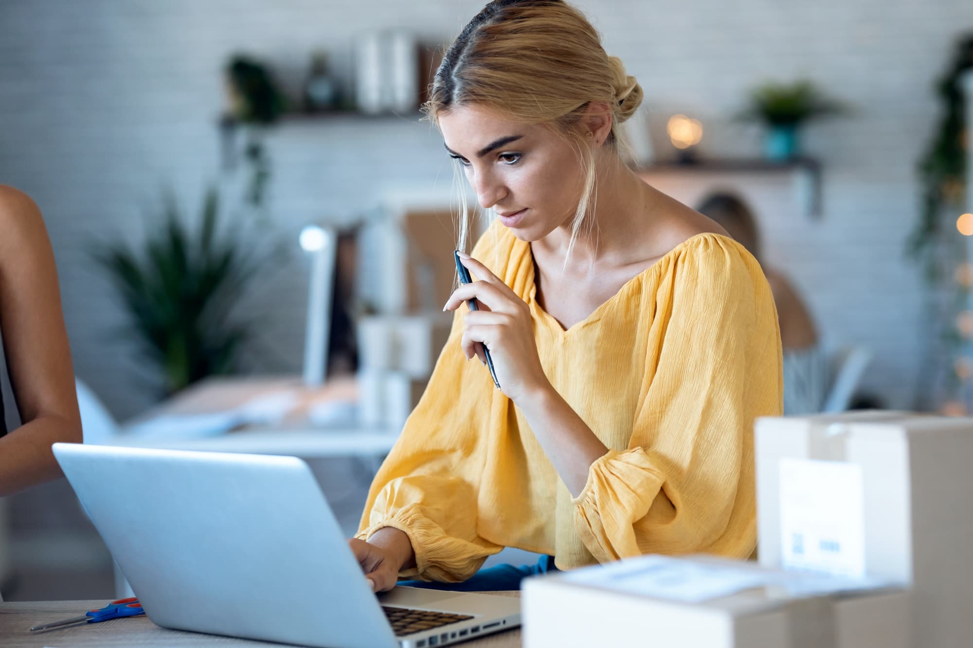 freelance business woman seller checking product order with computer