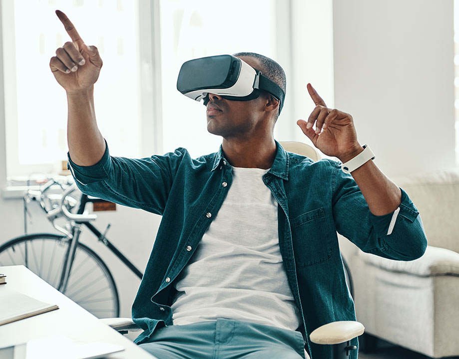 Educator using VictoryXR virtual learning platform with VR headset in a real-world learning environment