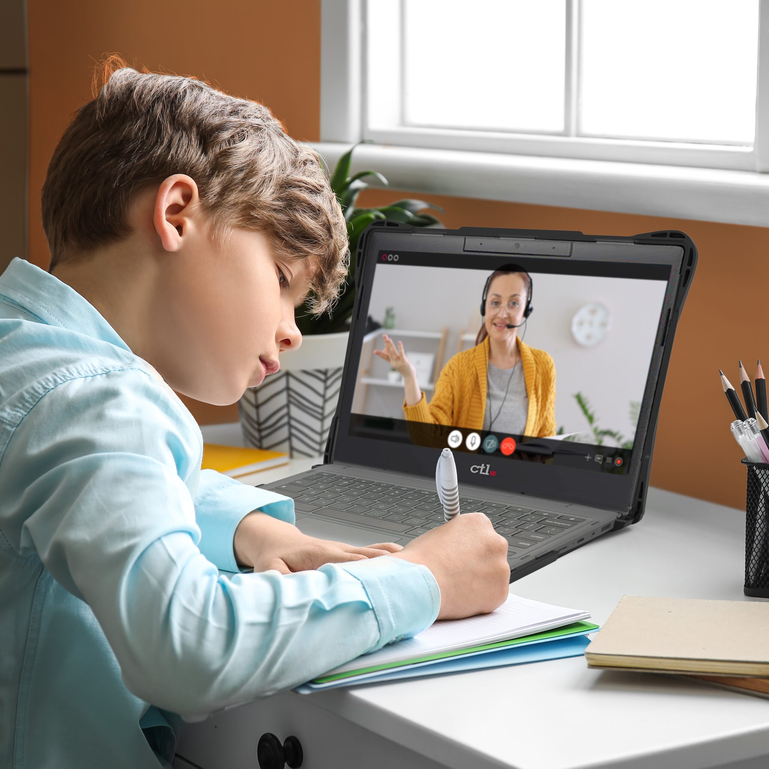 Student using a laptop with an InfoCase protective case during an online lesson